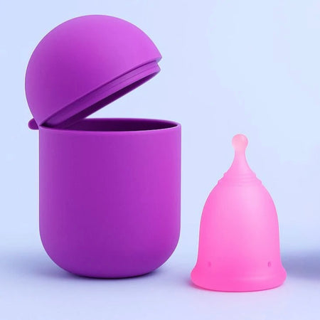 Bohokiwi Dark Purple steriliser pod open beside a Soft Pink menstrual cup
