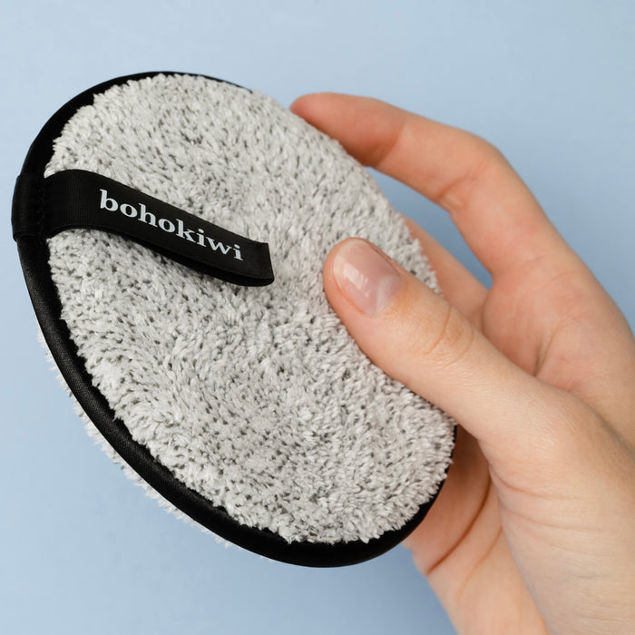Grey reusable makeup remover pad showing bohokiwi finger strap