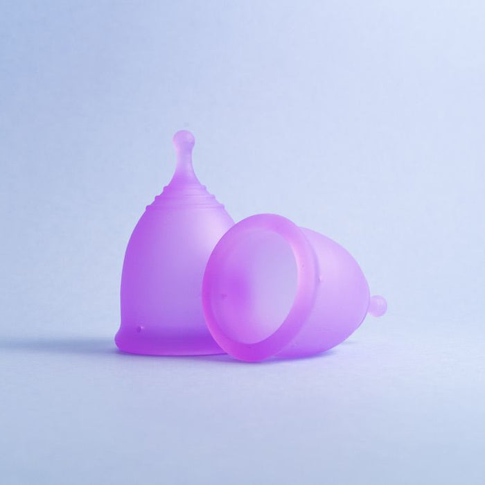 Two Lavender bohokiwi reusable menstrual cups, one upright and one on its side