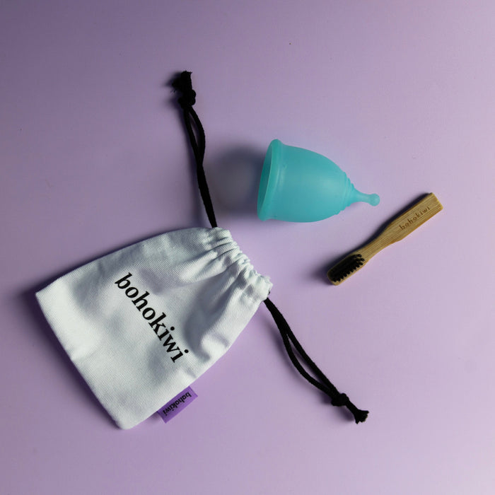 bohokiwi reusable menstrual cup in Sapphire Blue with cotton storage bag and bamboo cleaning brush