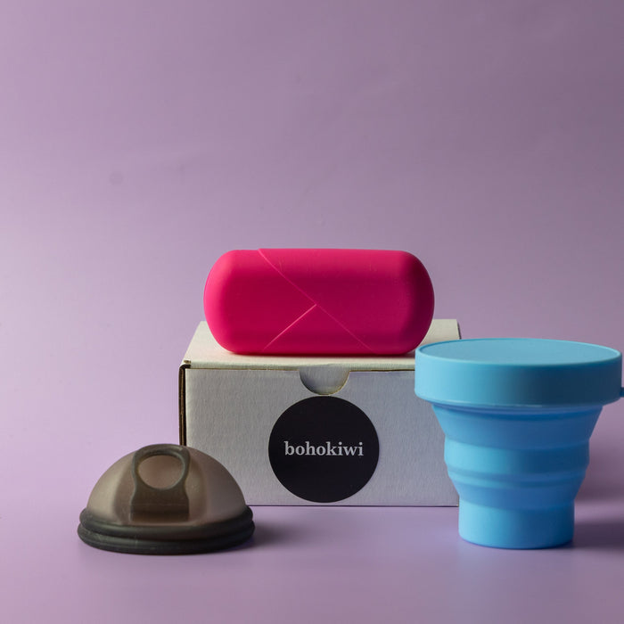 Bohokiwi Midnight Black menstrual disc with Pink capsule carrier case and Sky Blue collapsible steriliser