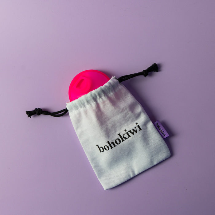 Bohokiwi Neon Pink menstrual disc with cotton storage bag