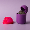 Bohokiwi Neon Pink menstrual disc beside Dark Purple steriliser pod holding a Midnight Black menstrual disc