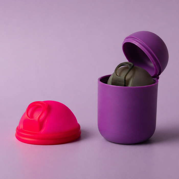 Bohokiwi Neon Pink menstrual disc beside Dark Purple steriliser pod holding a Midnight Black menstrual disc