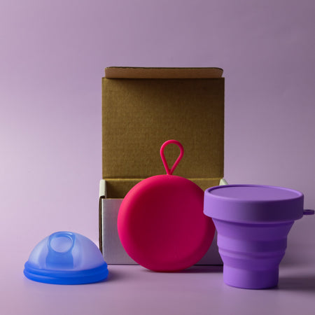 Bohokiwi Ocean Blue menstrual disc with Pink round carrier case and Purple collapsible steriliser
