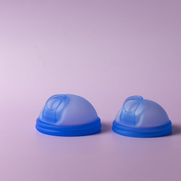 Two Bohokiwi Ocean Blue reusable menstrual discs with removal rings