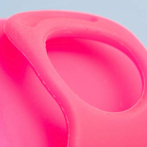     Close-up of Bohokiwi pink menstrual disc showing the removal ring