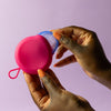  Bohokiwi Pink round menstrual disc carrier case being opened by hand