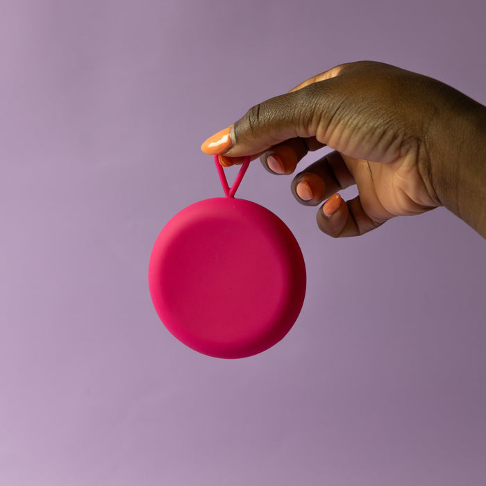  Bohokiwi Pink round menstrual disc carrier case held by its hanging loop