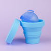 Sky Blue collapsible steriliser with Ocean Blue menstrual disc inside