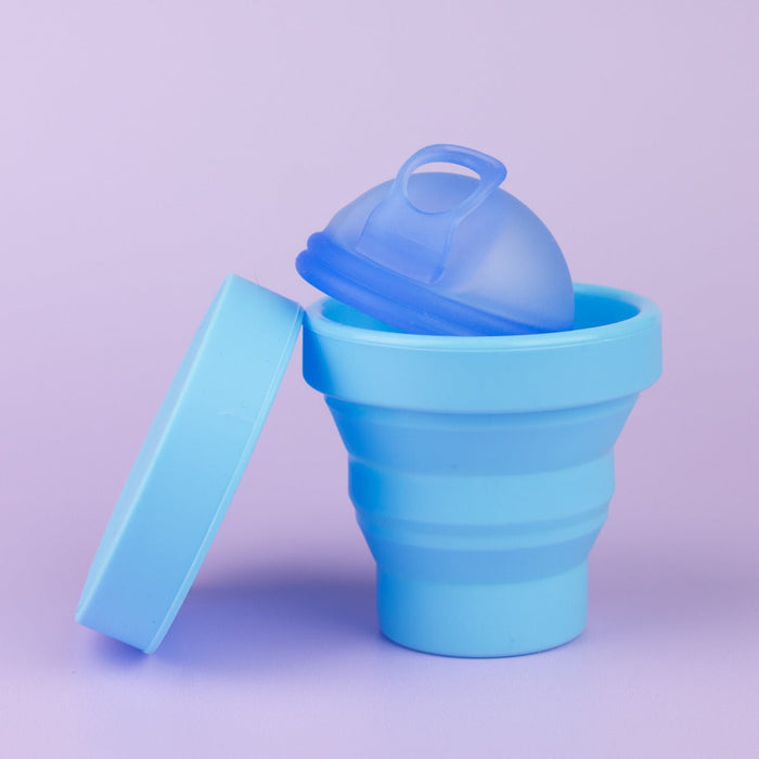 Sky Blue collapsible steriliser with Ocean Blue menstrual disc inside