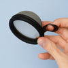     Bohokiwi Midnight Black menstrual disc held in hand showing the removal ring