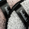 Close-up of bohokiwi reusable makeup remover pads with finger straps